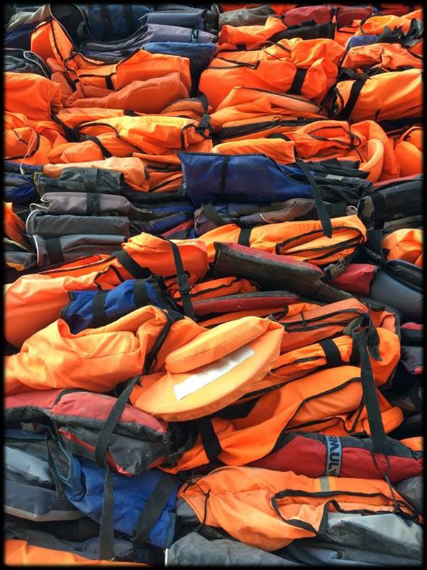 Stacked orange life jackets sewn from nylon oxford fabric